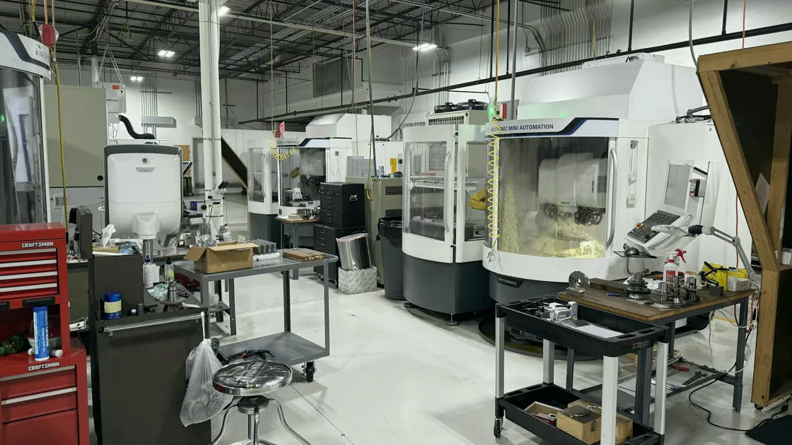 CNC machines and tool carts in a bright manufacturing workshop